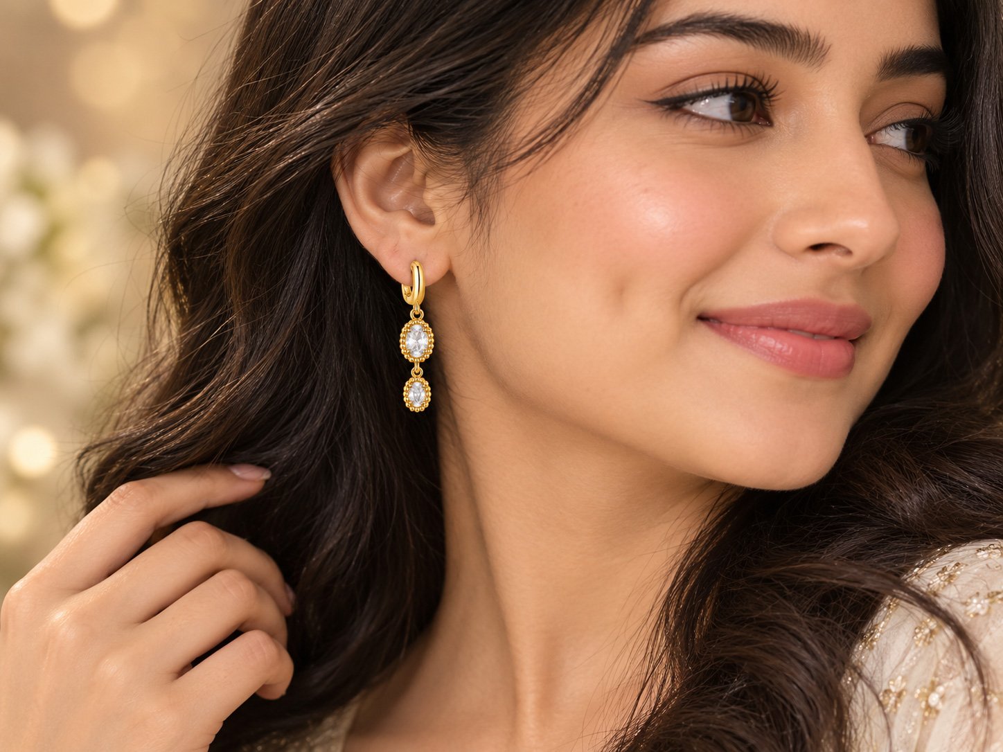 Model wearing VAKEZO gold crystal drop hoop earrings